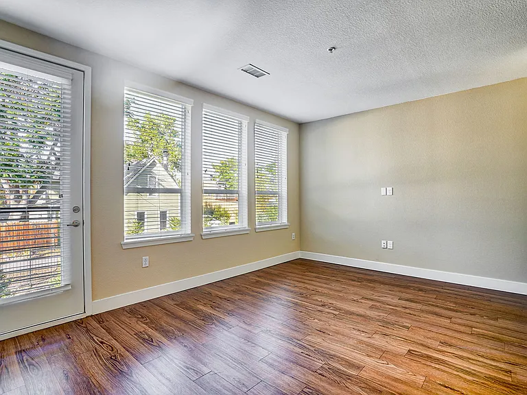Large windows and wood-style plank flooring in townhomes