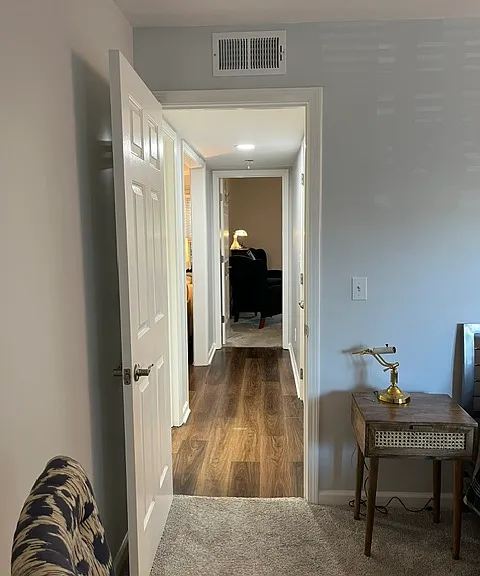 View from second bedroom to primary bedroom.