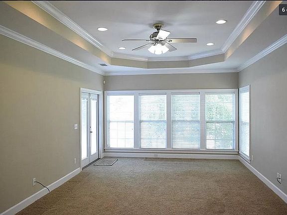 Large living area with tray ceilings and double crown molding, water views