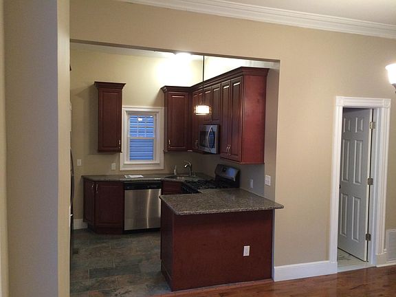 Kitchen w/extended countertop for stool seating. Second entr
