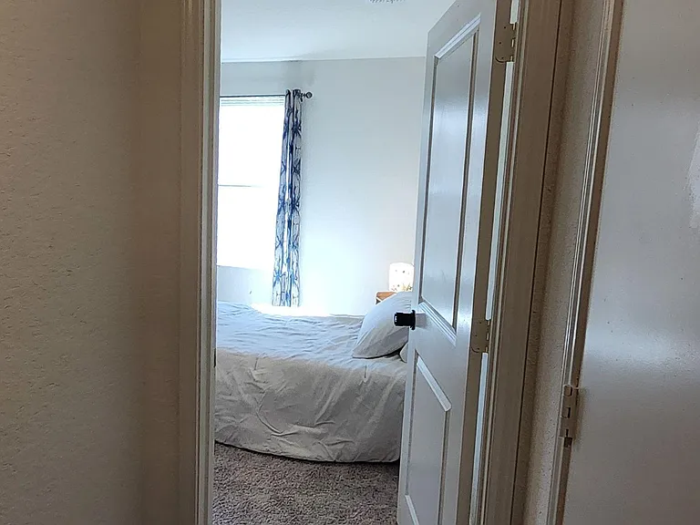 Your room has a comfortable bed and a pretty night stand.