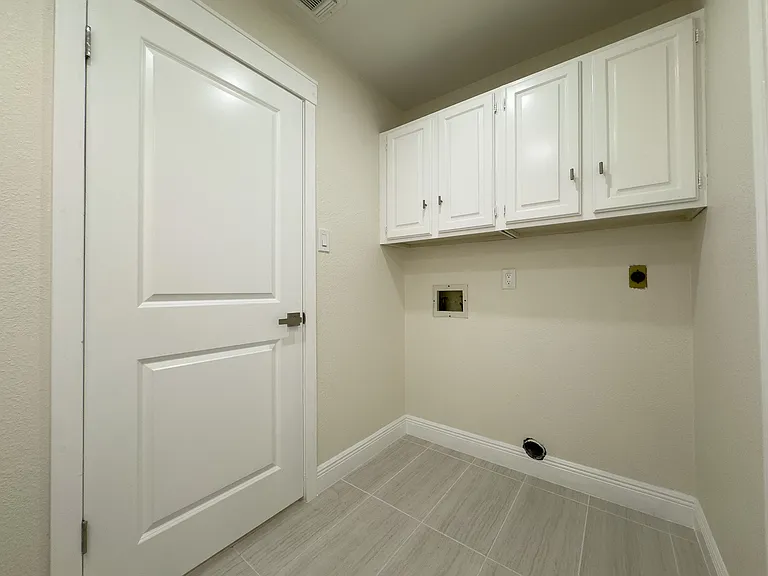 Laundry area with hookups for washer and dryer.