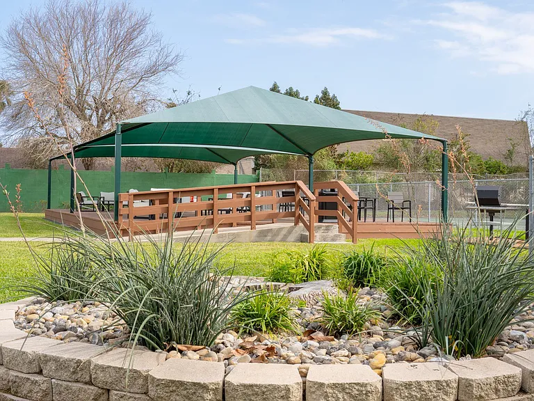 Shaded outdoor seating area perfect for gatherings at Borders Apartments Brownsville Texas.