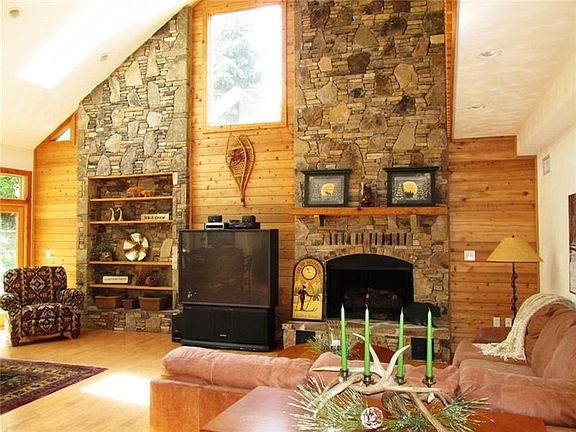 How impressive and open is this room! Skylights, transoms, custom windows and panes are throughout the home.