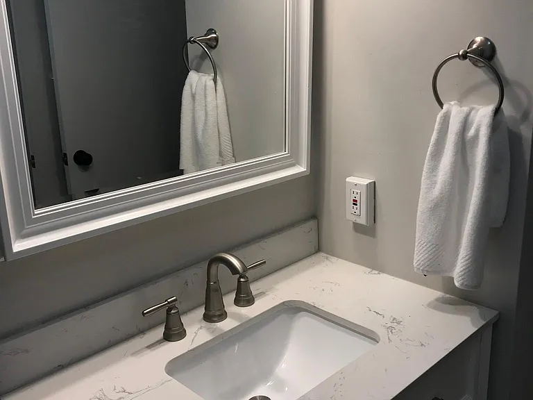Brand new mirror and vanity with carrara stone top.