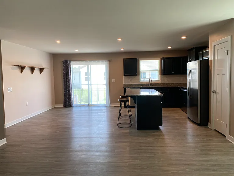 The kitchen opens out to the dining room and living room areas.