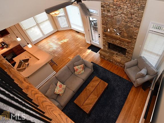 A view of the same area from the "catwalk" connecting the bedroom winds upstairs.  Notice all the light and big windows