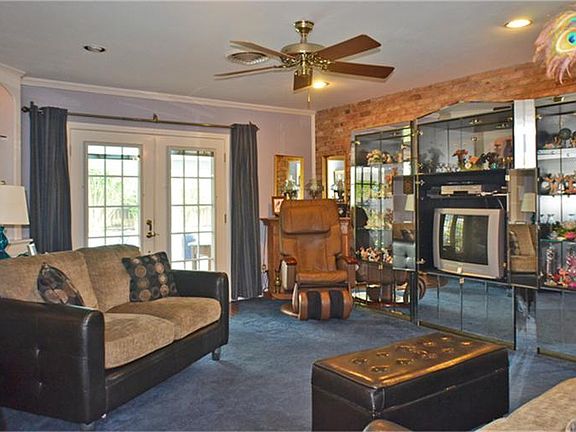In the door, down a short hall and here is your den with double doors to the pool, yard, and gazebo, to left is the formal living and dining.