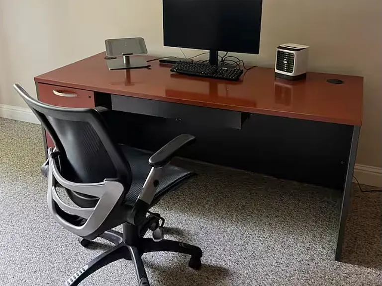 Spacious work desk with a large monitor - ready to get you going.