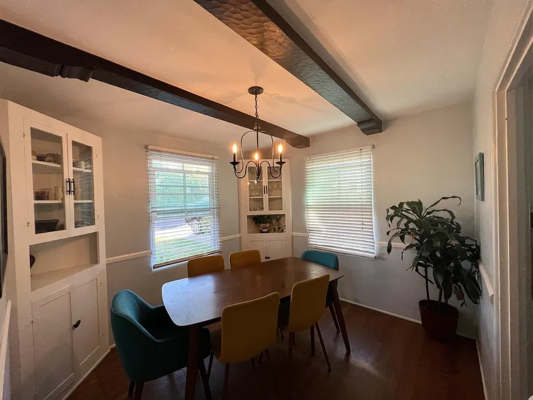 Dining room with original built-in cabinets and wood beams