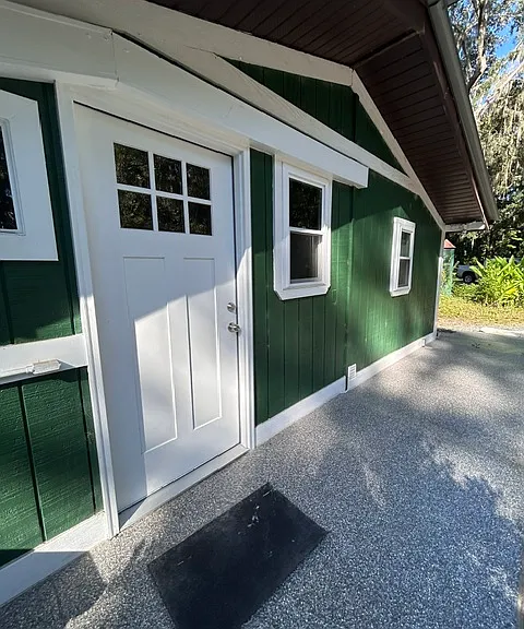 Door to the back door leading to kitchen directly off parking area