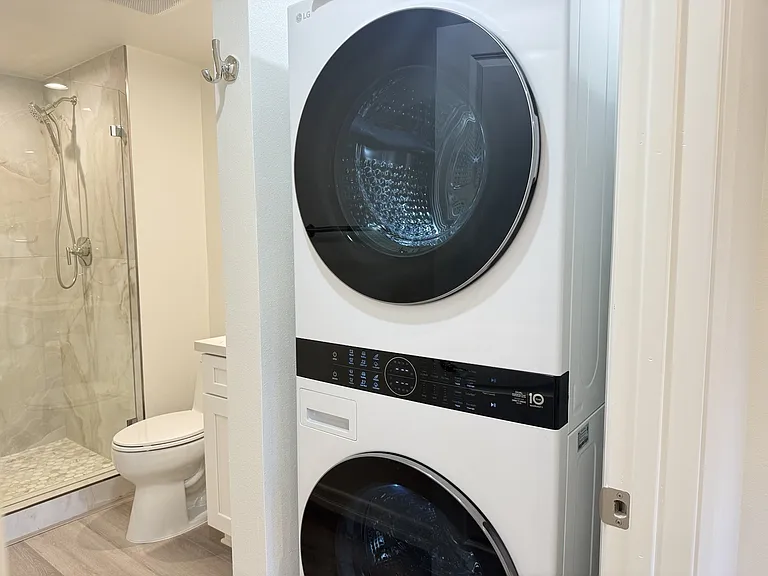 Full-size LG ThinQ washer & dryer conveniently located inside the unit.