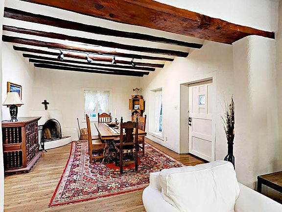 The elegant dining area has a wood-burning kiva fireplace for mealtime ambience.
