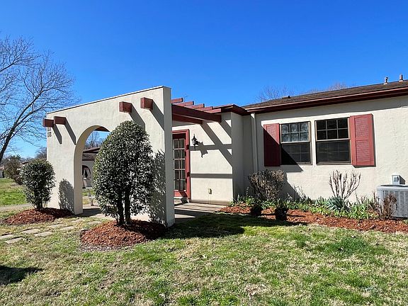 Beautiful side view of front double doors and entry patio