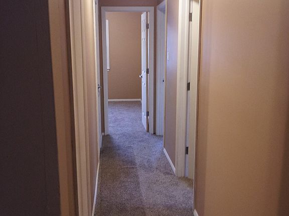 Hallway leads to bedrooms, bathroom, and private laundry room.