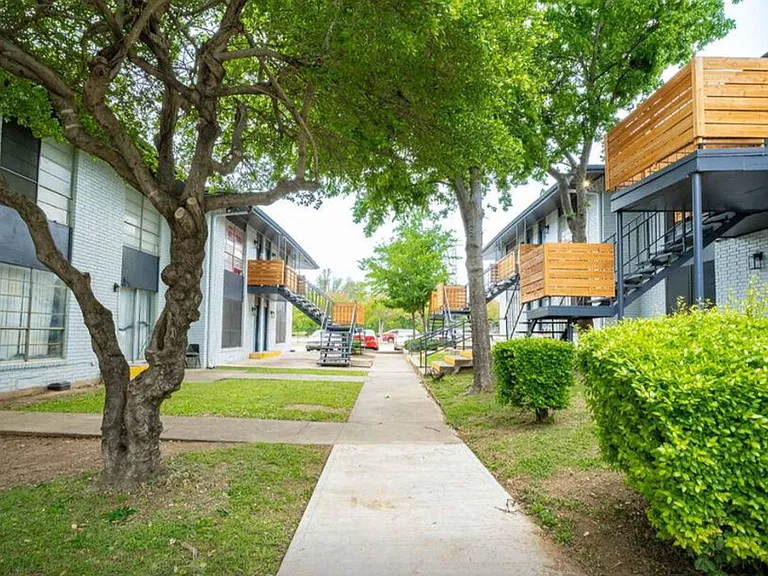 Tree-lined walkways in a peaceful Dallas apartment community