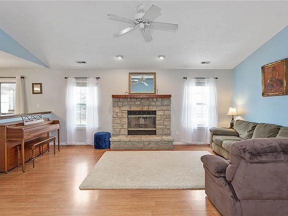 Great Room with vaulted ceilings and Gorgeous Stone Fireplace.