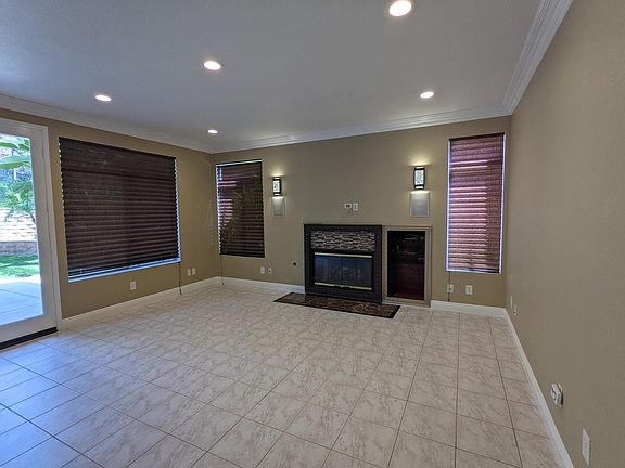 The family room open to the kitchen has a gas fireplace and a place to hang your television