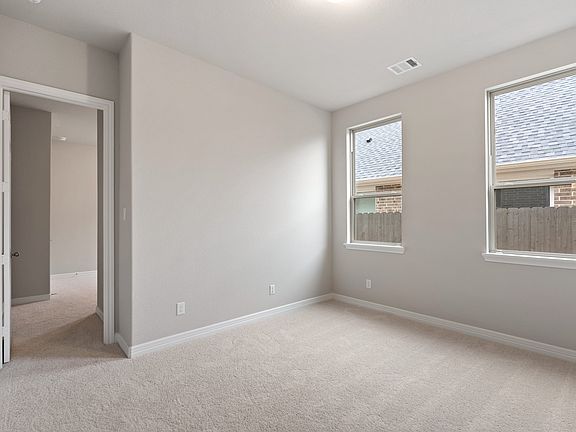 Spacious in-law suite sitting area with large windows that flood the space with natural light, seaml