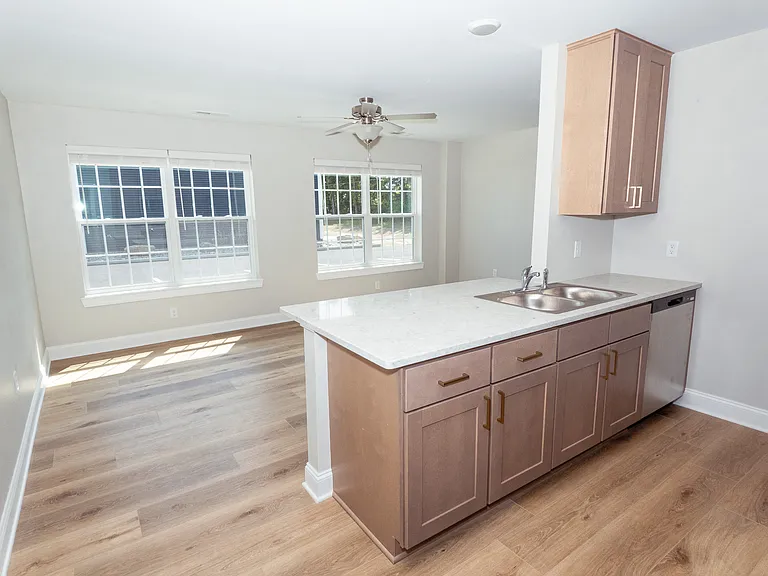 View of the living room and dishwasher side of kitchen from entrance door.