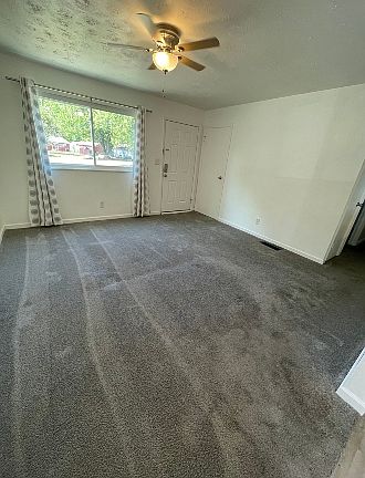Family room from the kitchen toward the front yard with a new ceiling fan. Carpets shampooed. 14' 3" x 13' 5"