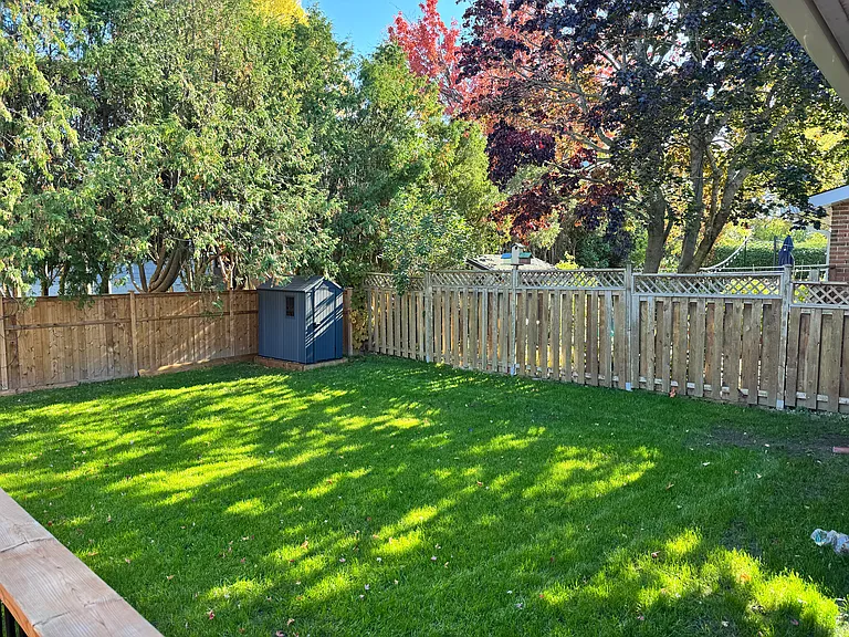 Large, fully fenced private backyard, perfect for families and dogs at our Ottawa rental property.