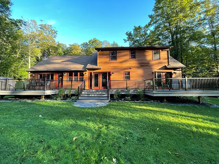 The deck runs along the entire width of the house