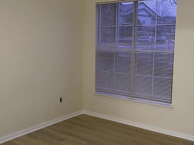 Spacious primary bedroom with large window and new remote (timer setting, etc.) controlled ceiling fan.
