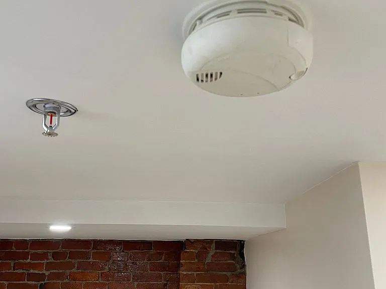 This renovated buildings life safety features include a new sprinkler system and fire alarm system.