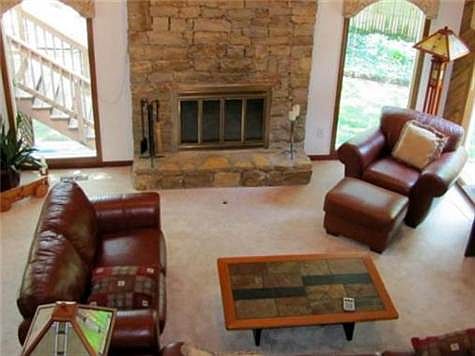 Great Room with Stone Fireplace and Vaulted Ceiling