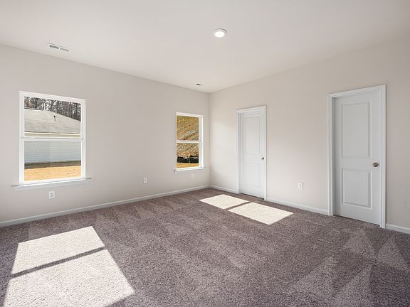 The spacious master bedroom is the perfect place to unwind after a long day