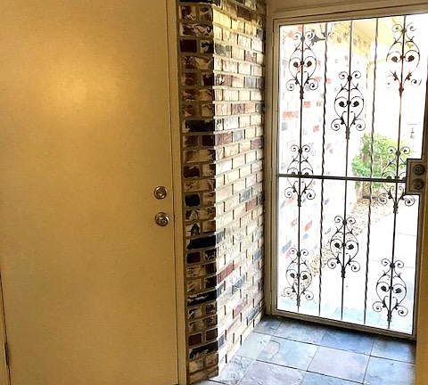 Entryway and door to garage, sky light in entryway