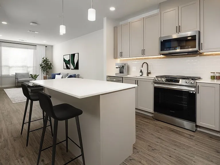 Upgrade Scheme kitchen with stainless steel appliances, white quartz countertops, grey cabinetry, and hard surface flooring