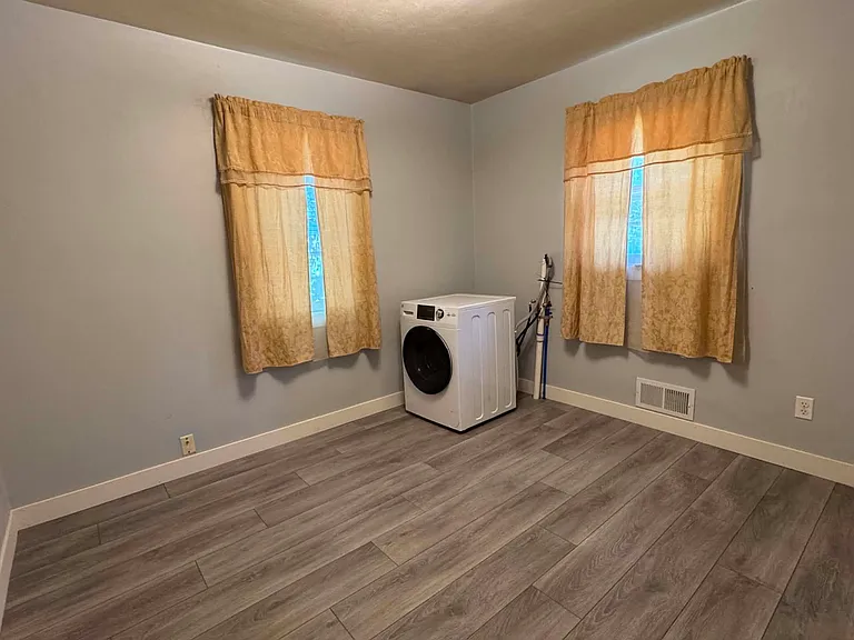 Main floor bedroom 3 with washer/dryer combo