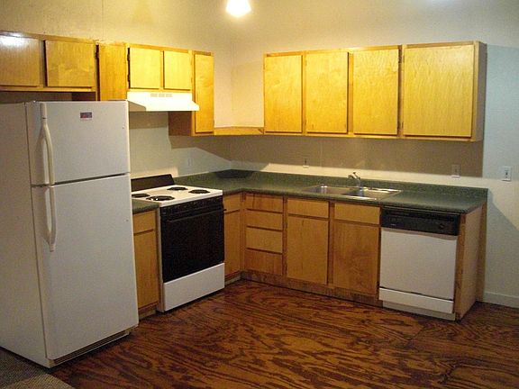 Compact kitchen with fridge, stove/oven, dishwasher.
