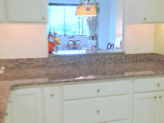 Looking From Kitchen Across Bar To Living Room Balcony