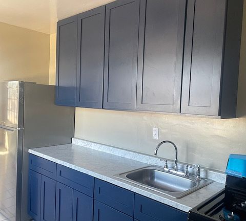 Updated Kitchen with brand new cabinets, sleek countertops, and stainless steel appliances.