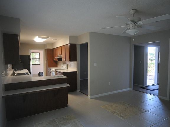 dining room into kitchen, entry door visible