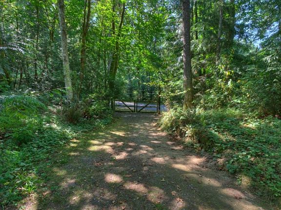 The 2nd gate on the property, leading to the road behind the home. The home is situated on the property to maximize privacy as well as usable land for horses, gardening, or just tranquility. There are many fruit trees as well as native trees that have been planted or nurtured on this property.