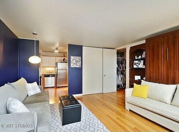 Room with custom wall bed (Queen mattress) and couch. Wall bed need not be used and could serve as accent / decorative feature.