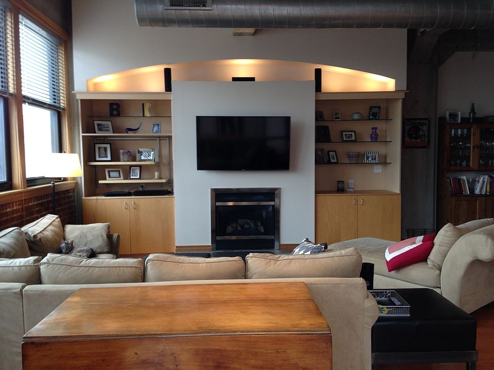 Open living area w/built in shelves and gas fireplace