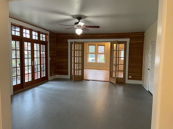 Large living room with french doors open to 300sqft covered porch. Also french doors into large bedroom.