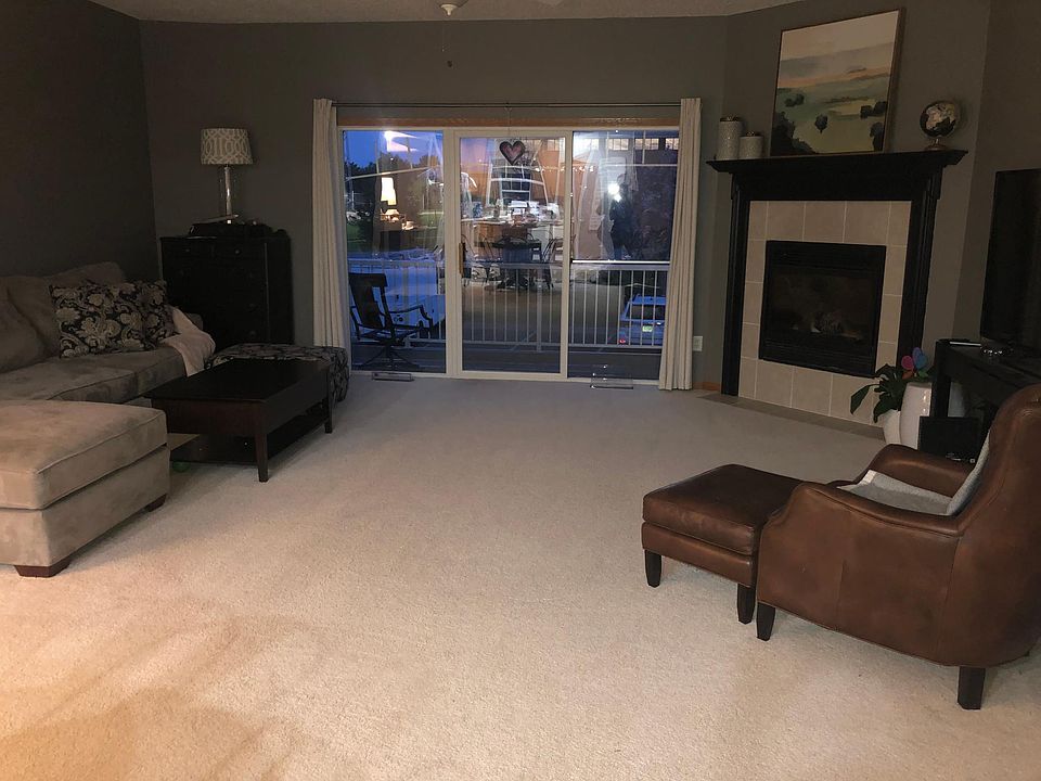 Living room with fireplace and 3 panel patio door.