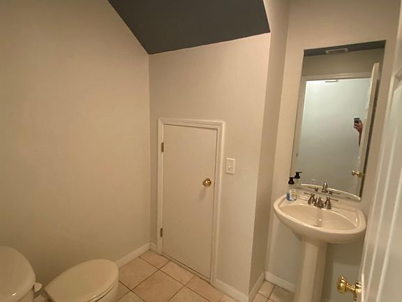 Half-bath. First level. Also, storage area.