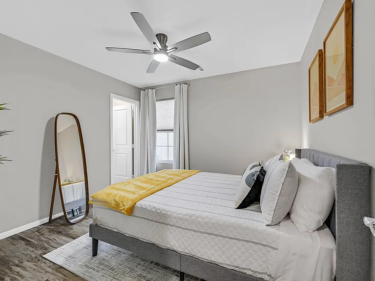Bedroom 2 with Queen size bed, walk-in closet, ceiling fan, and black out curtains