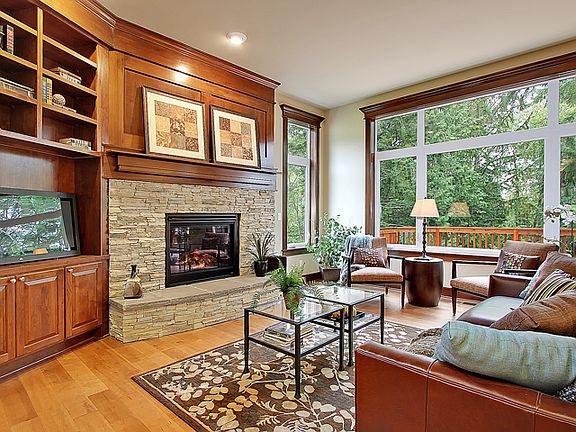 Family room with large picture window with peaceful greenbelt views.