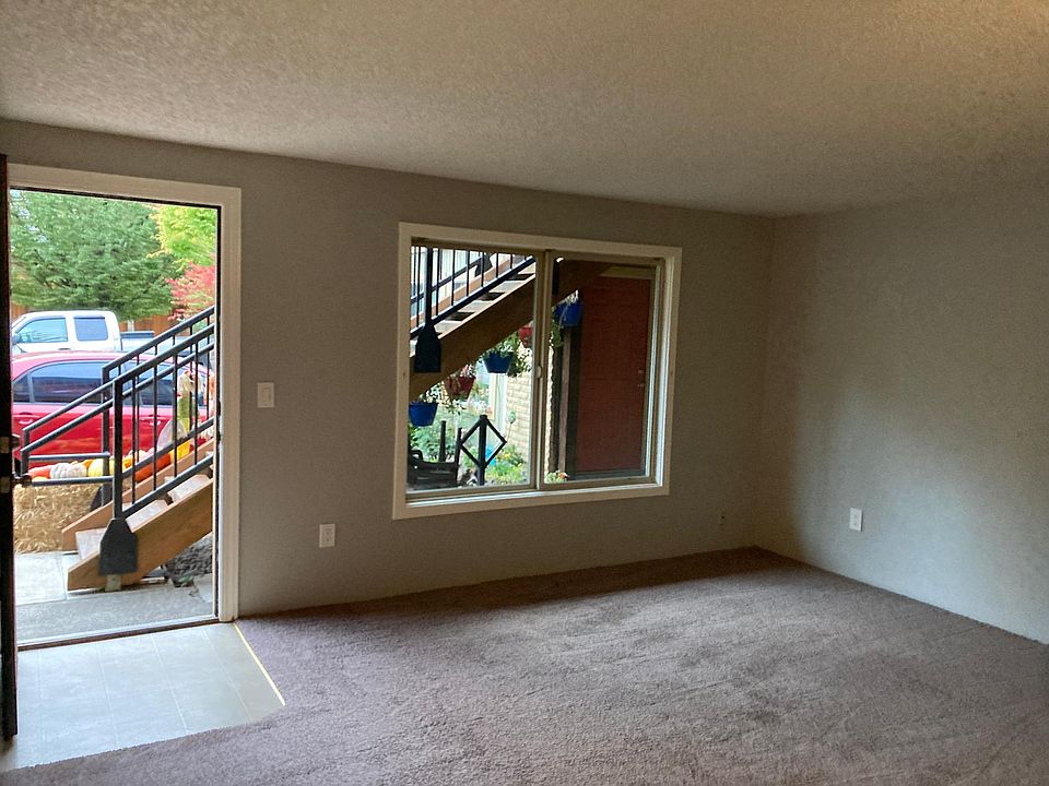 Pic from your living room looking out front door. New top down or bottom up blinds and blackout curtains are being installed and not shown.