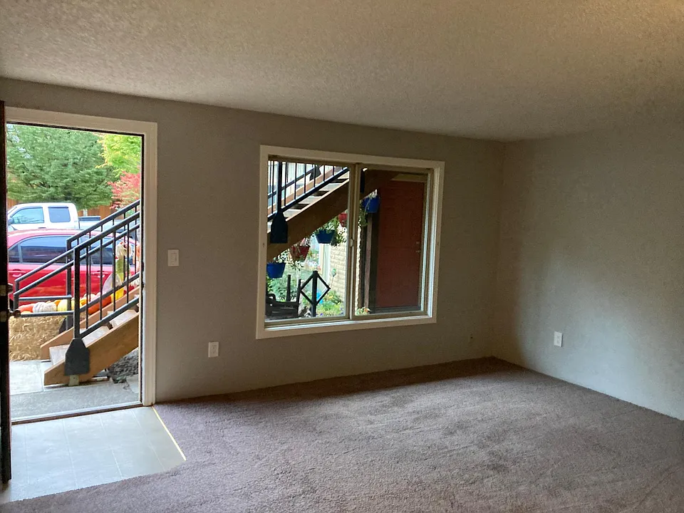 Pic from your living room looking out front door. New top down or bottom up blinds and blackout curtains are being installed and not shown.