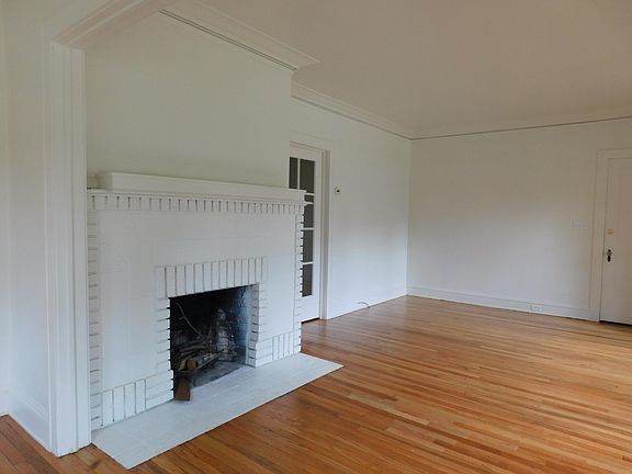 Living room right side view and glassed door that leads to bedrooms.