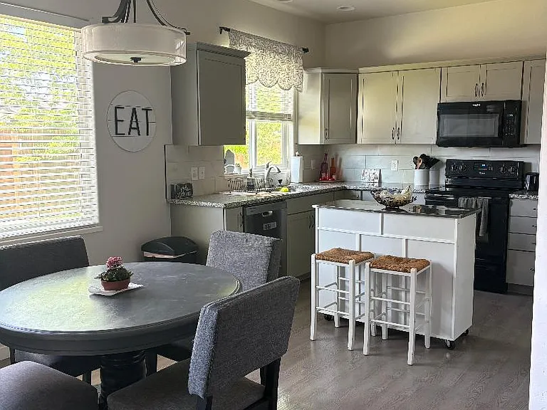 Kitchen and eating area (new refrigerator and dishwasher) also has a microwave and range